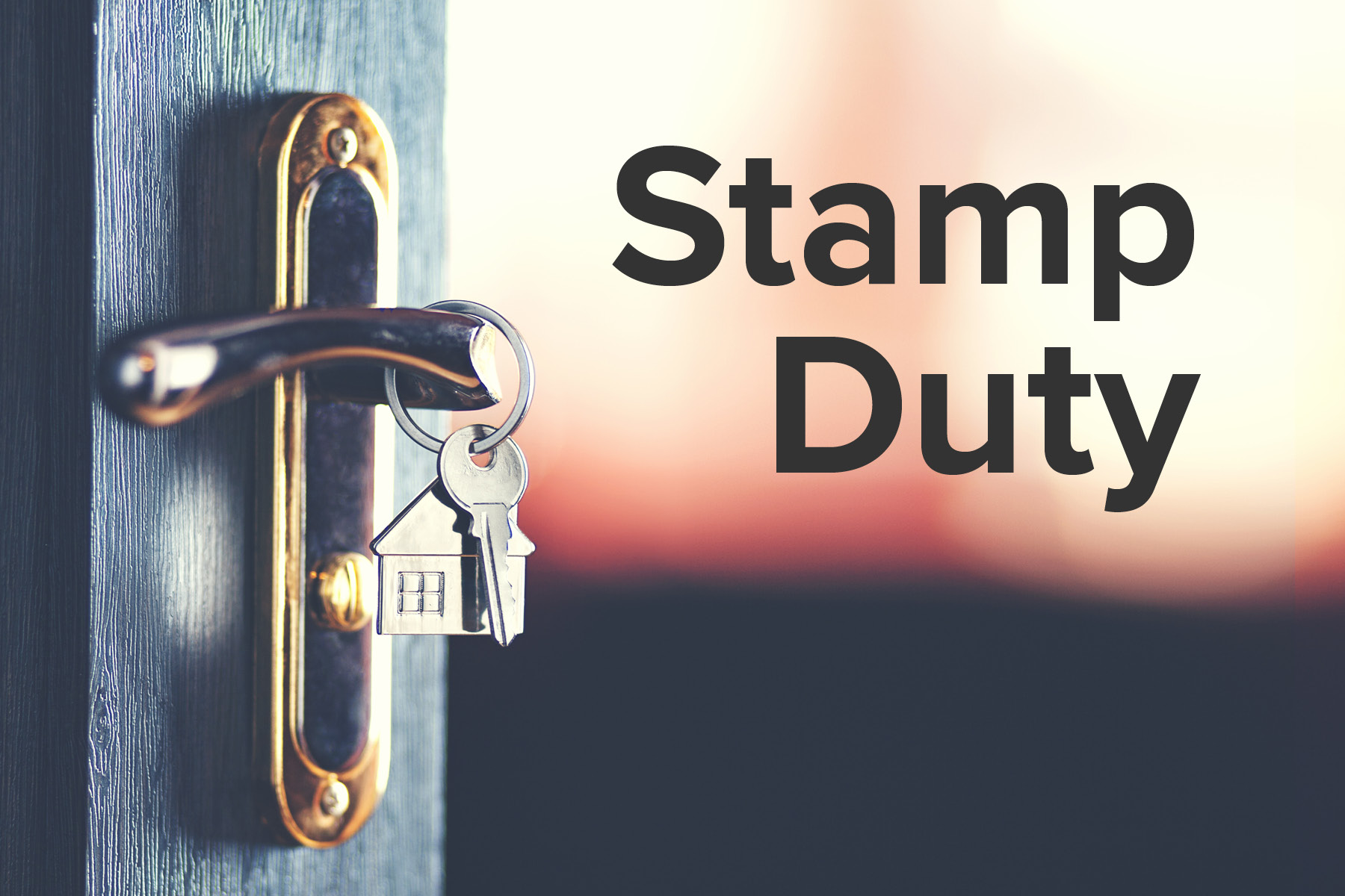 Key and house keyring on a door handle with the words stamp duty
